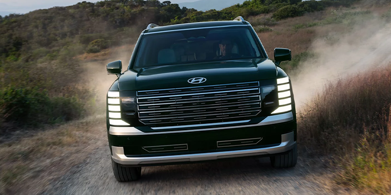 The front view of a Hyundai Palisades as it drives towards the viewer.