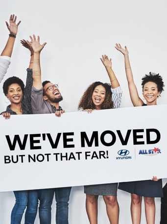 we have moved but not far banner with people lifting arms